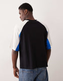 ASOS DESIGN boxy oversized t-shirt with cut and sew panelling and sports graphics in off white.
