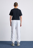 Nike Sportswear AIR - Tracksuit bottoms - photon dust/tropical twist/iron grey