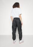 Nike Sportswear WINDRUNNER - Tracksuit bottoms - black/white