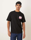ASOS DESIGN relaxed T-shirt with color block flower graphic in black.