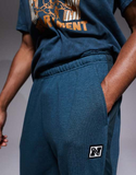 Nike Training Heritage Dri-FIT joggers in blue