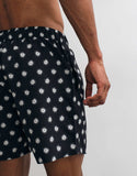 ASOS DESIGN swim shorts in mid length in black print