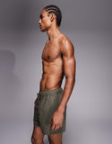 ASOS DESIGN short length swim shorts in khaki-green leopard jacquard