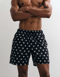 ASOS DESIGN swim shorts in mid length in black print
